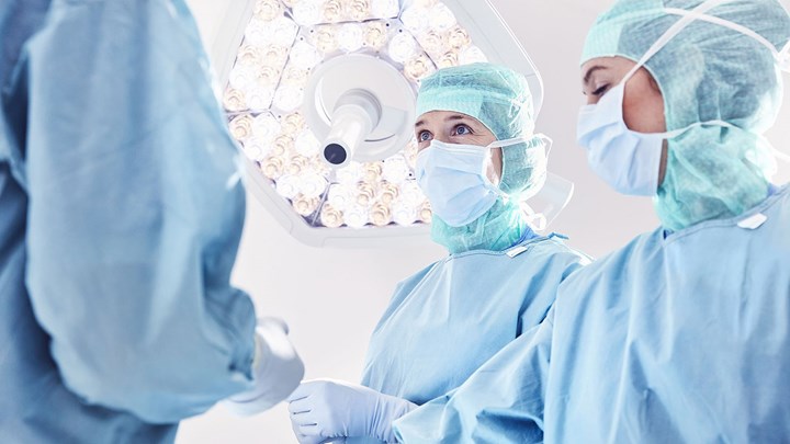 three surgeons in an operation room